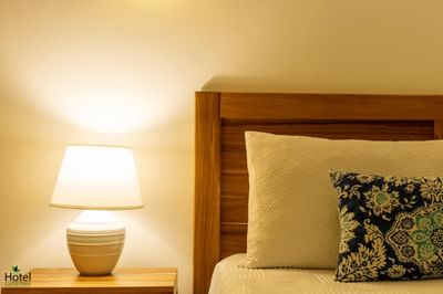 Close-up of a cozy bed and lamp in a Junior Suite at La Casita by the Hub, a great place to stay in La Romana
