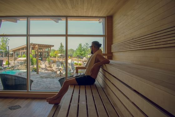 A man relaxing in the Spa sauna at ReStays Ottawa