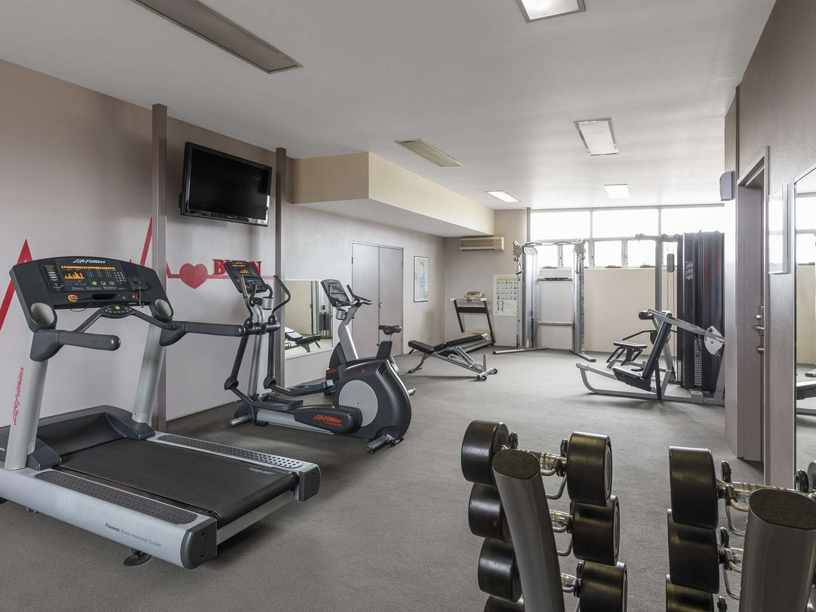 Exercise machines arranged in the gymnasium at Nesuto Hotels