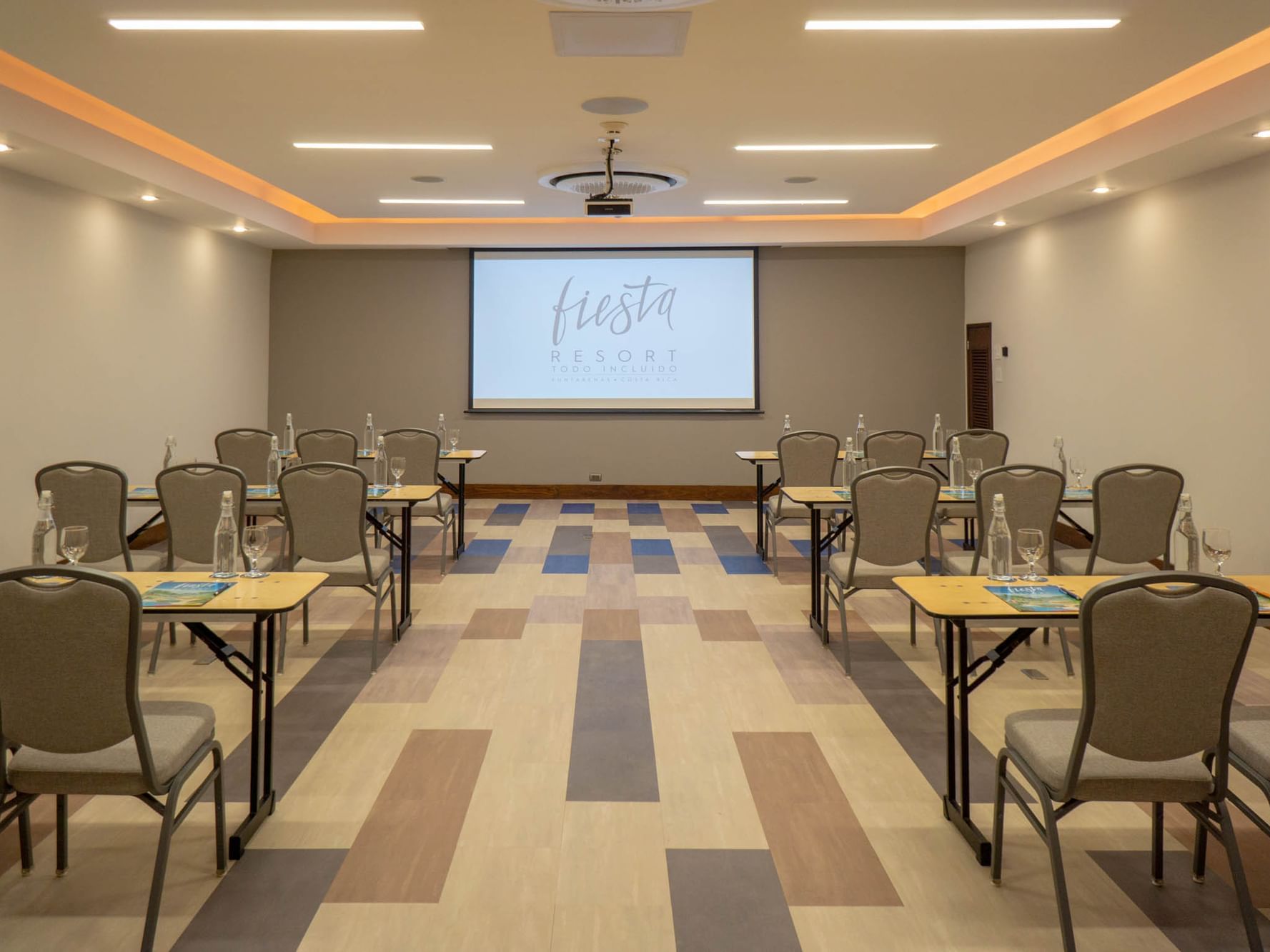 Tempisque Meeting rooms arranged with screen and tables, chairs at Fiesta resort