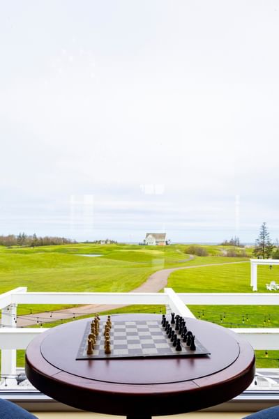 Chess board on table overlooking green fields at Rodd Crowbush Golf & Beach Resort, a top choice among pei resorts
