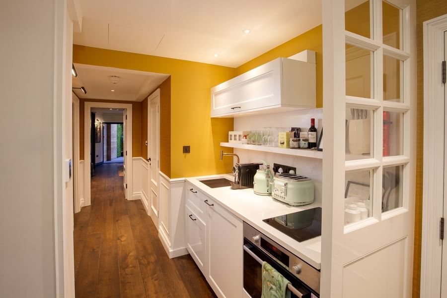 Kitchenette with white counters & appliances in Hyde Park Suite at The Capital Hotel, Apartments and Townhouse
