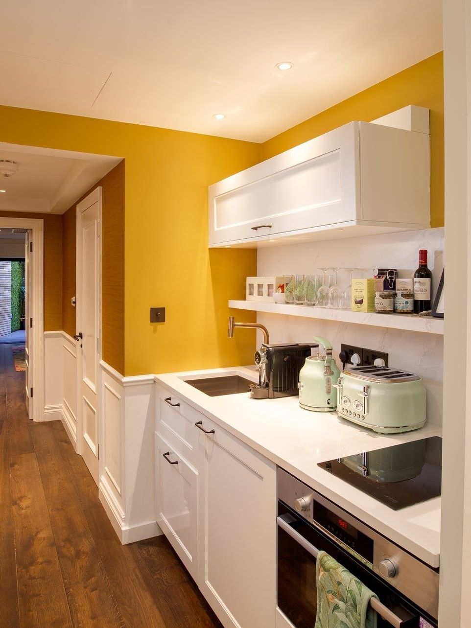 Kitchenette with white counters & appliances in Hyde Park Suite at The Capital Hotel, Apartments and Townhouse