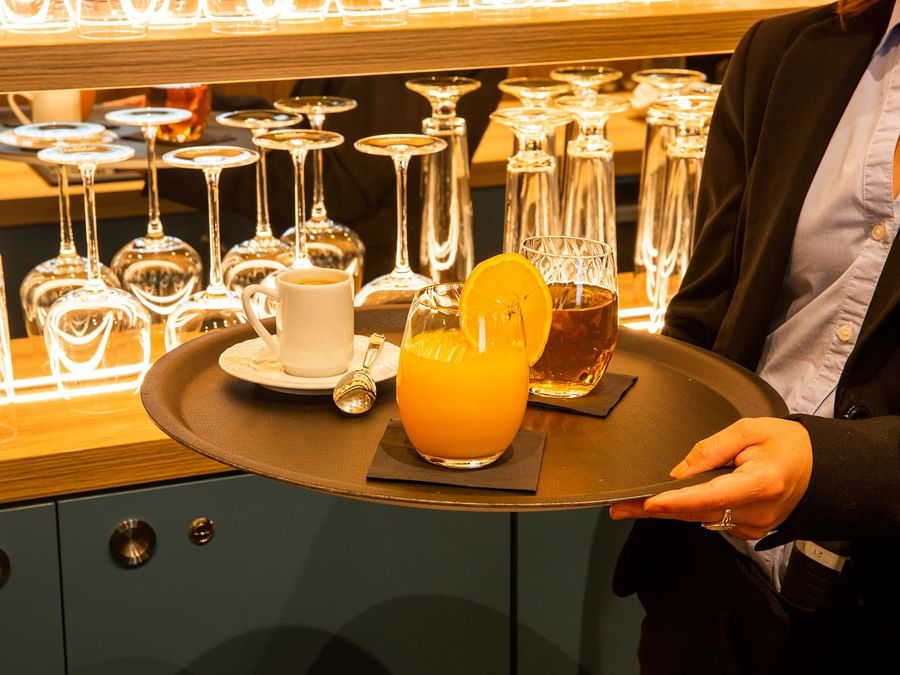 A waiter serves drinks at Hotel des sources