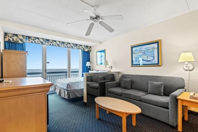 Living area arranged with cozy sofa in Prime Studio at The Yachtsman Resort