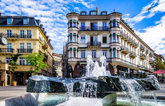 An image with a fountain in front of a building near Radisson Bl