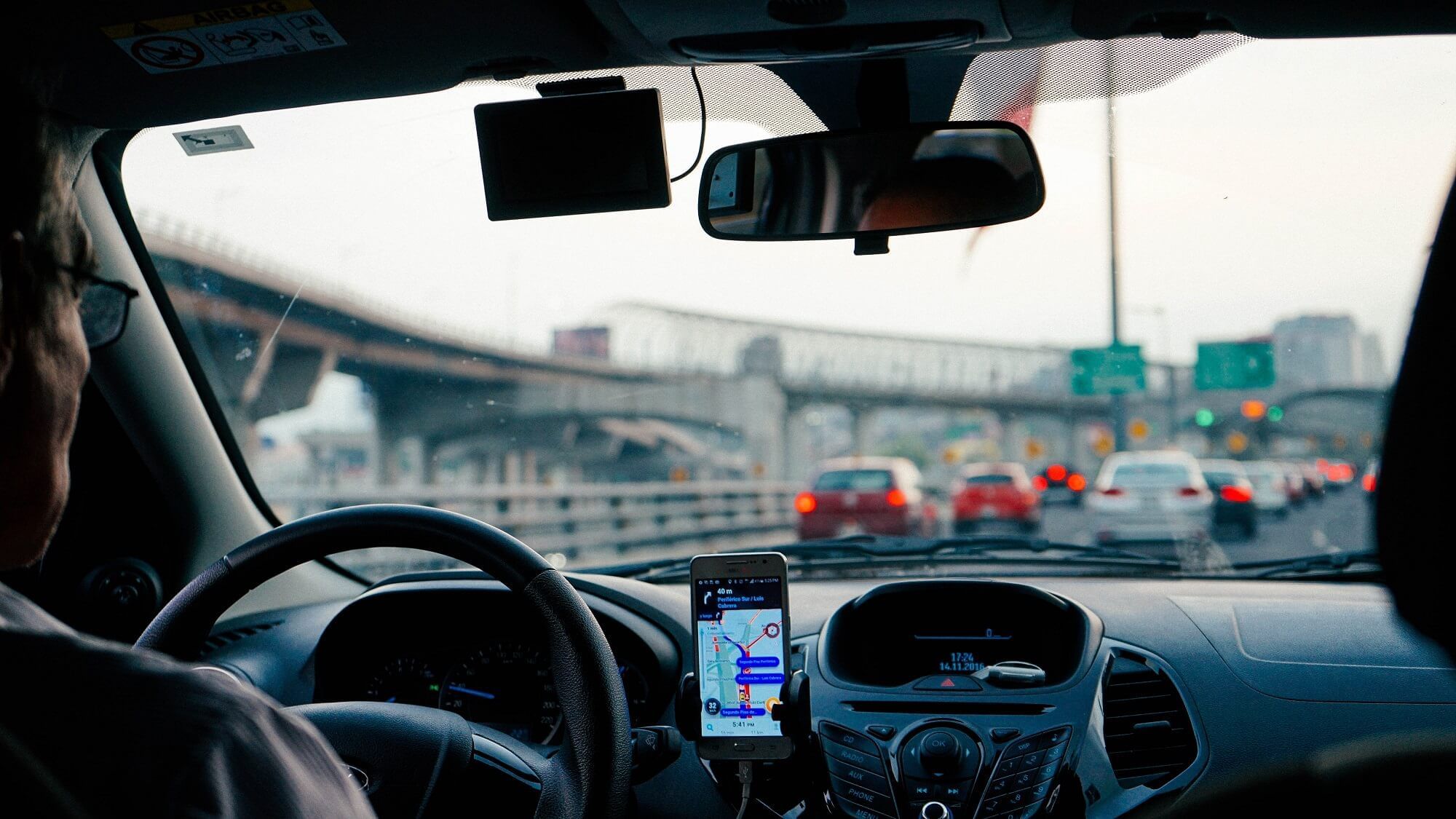 A person driving a car while looking the map near Waikiki Resort Hotel