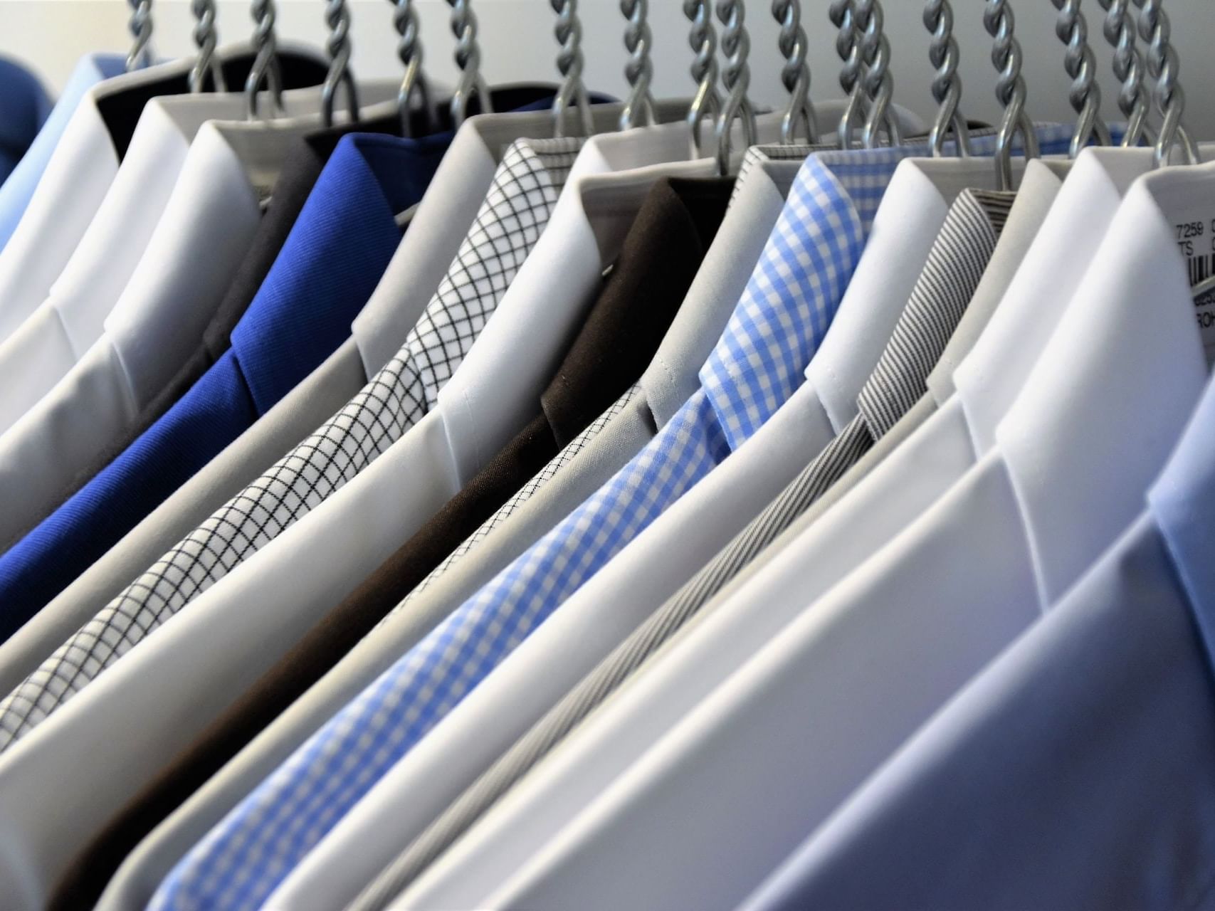 Close-up of shirts hung on a rack in the laundry at Carlton Hotel Singapore