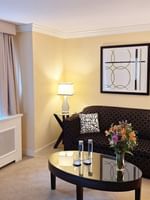 Patterned sofa with coffee table near window in Premium Suite Two Queen Beds at Warwick Allerton Chicago