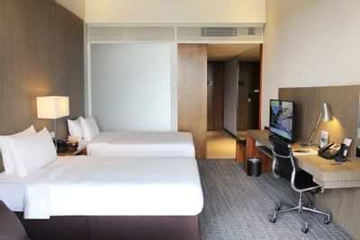 Twin bed and furniture in Deluxe Room at Amara Sanctuary Resort