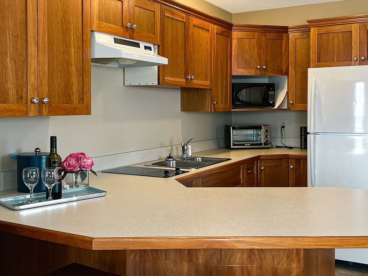 Kitchen with fridge, microwave, sink, and table