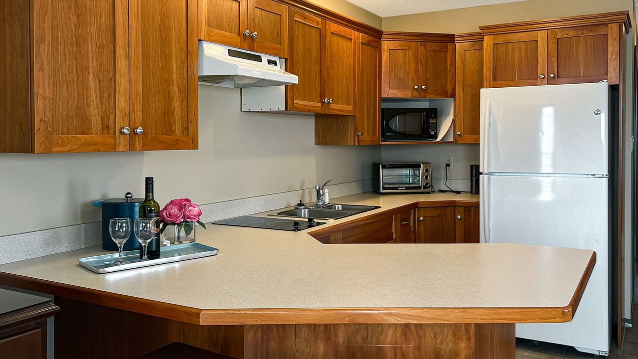 Kitchen with fridge, microwave, sink, and table