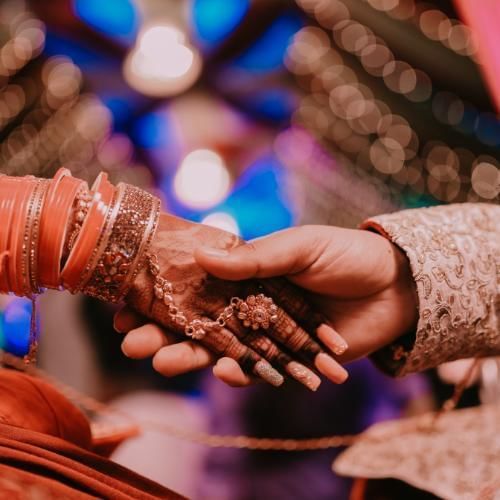 Bride and groom holding hands at their Indian wedding