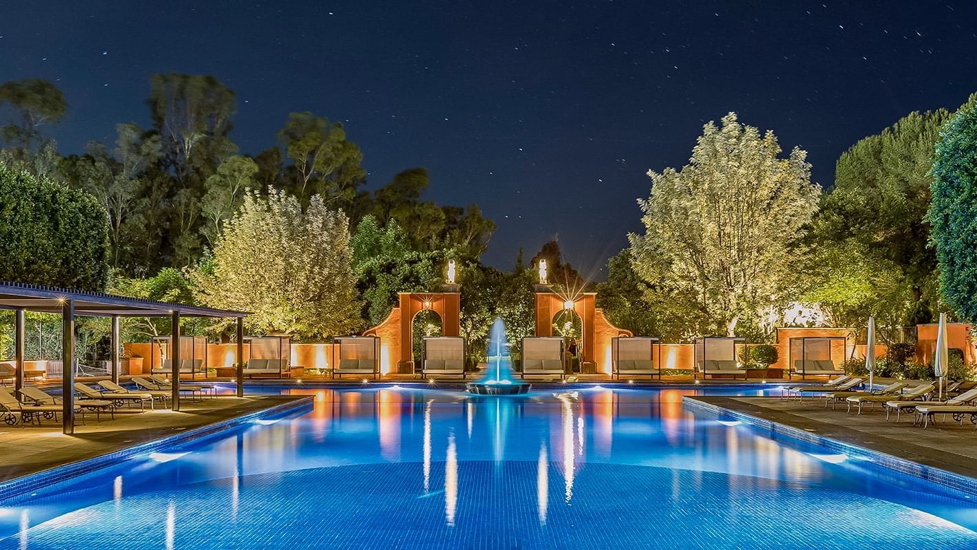 Outdoor pool area at Fiesta Americana Hacienda at night