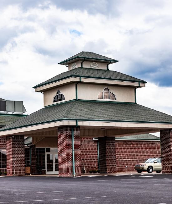 Exterior view of South Branch Inn Romney with cars parked in parking slots