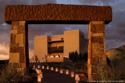 Enchanting pathway lined with luminarias leading to Hilton Santa Fe Buffalo Thunder at twilight