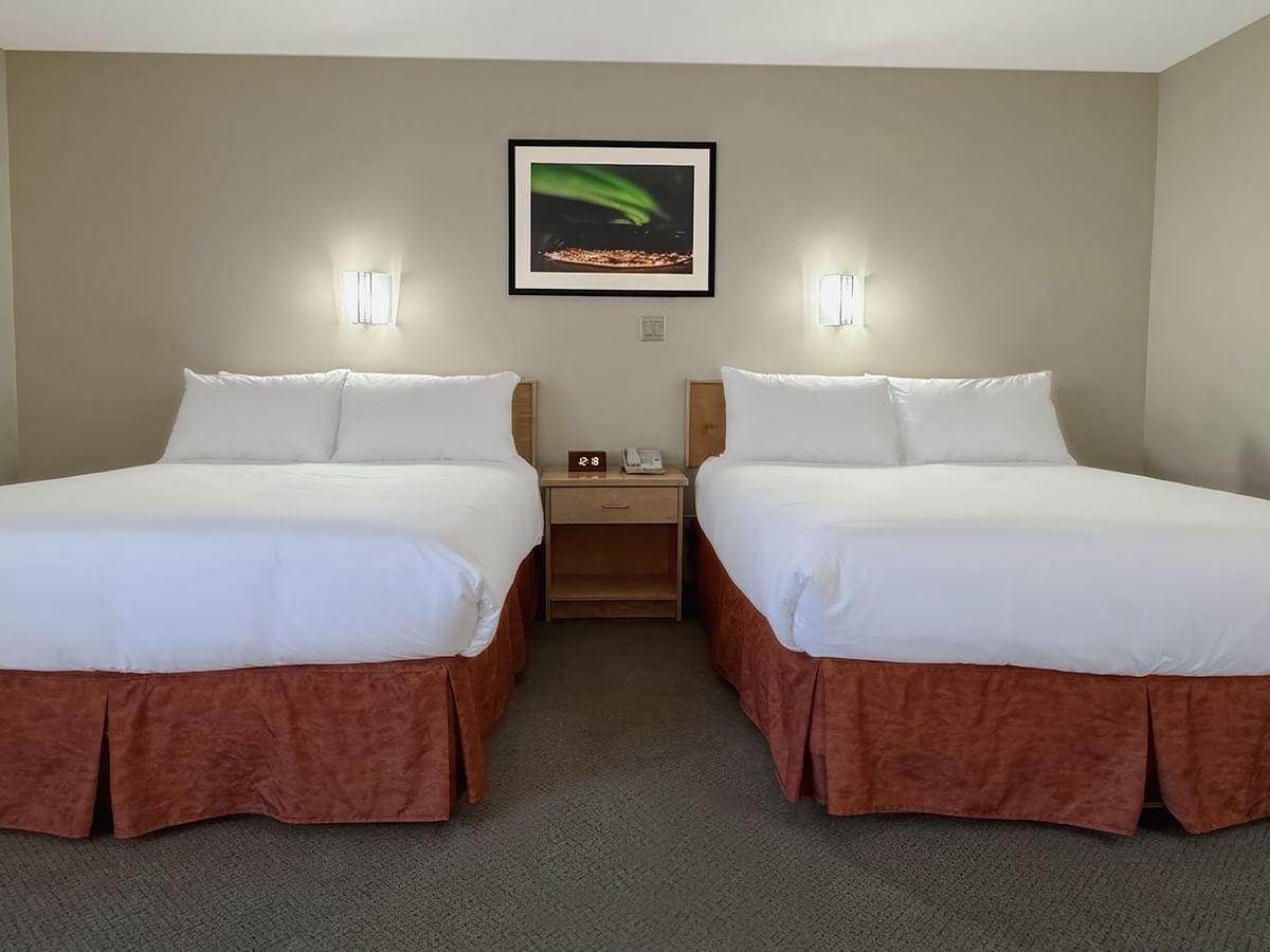 two queen beds in a hotel room