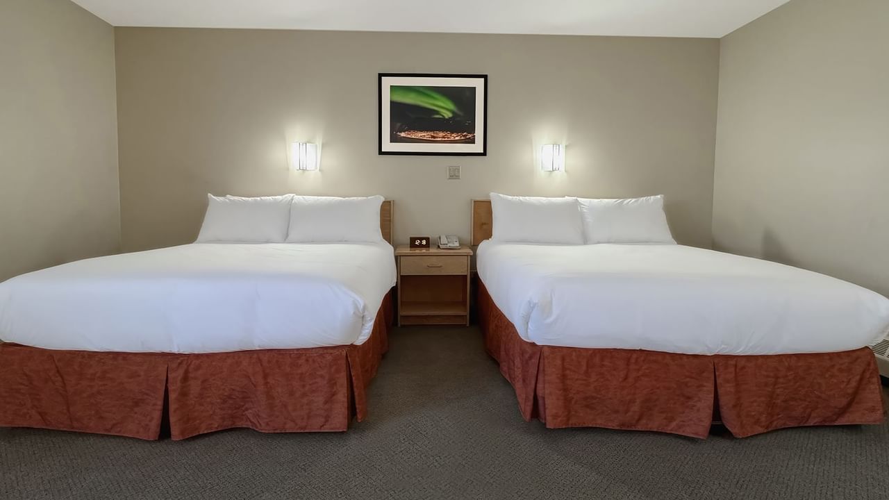 two queen beds in a hotel room