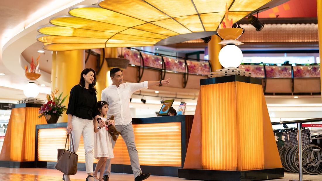A family of 3 shopping in a mall near Sunway Resort