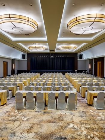 Saujana Ballroom at The Saujana Hotel Kuala Lumpur with draped tables, soft lighting, and a presentation stage
