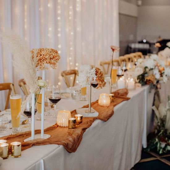 Rustic wedding reception set up with candles at Pullman Magenta Shores