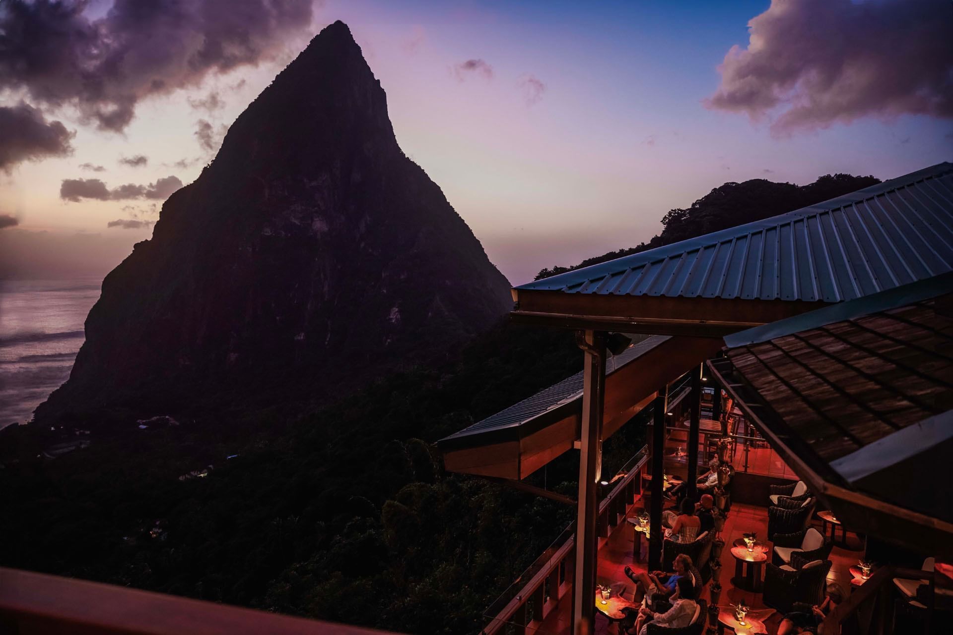 Outdoor restaurant overlooking a mountain peak and ocean at Ladera Resort