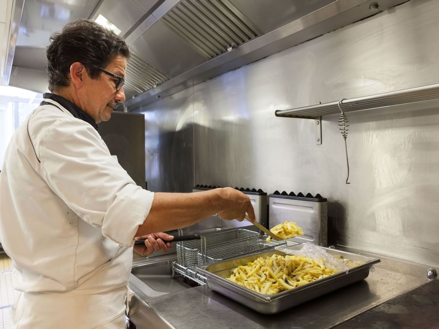 A picture of a chef cooking fresh fry at Hotel Du Phare