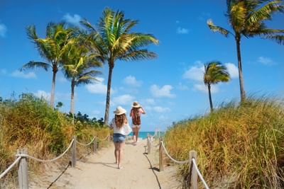 Two girls walking towards the beach at Clevelander South Beach
