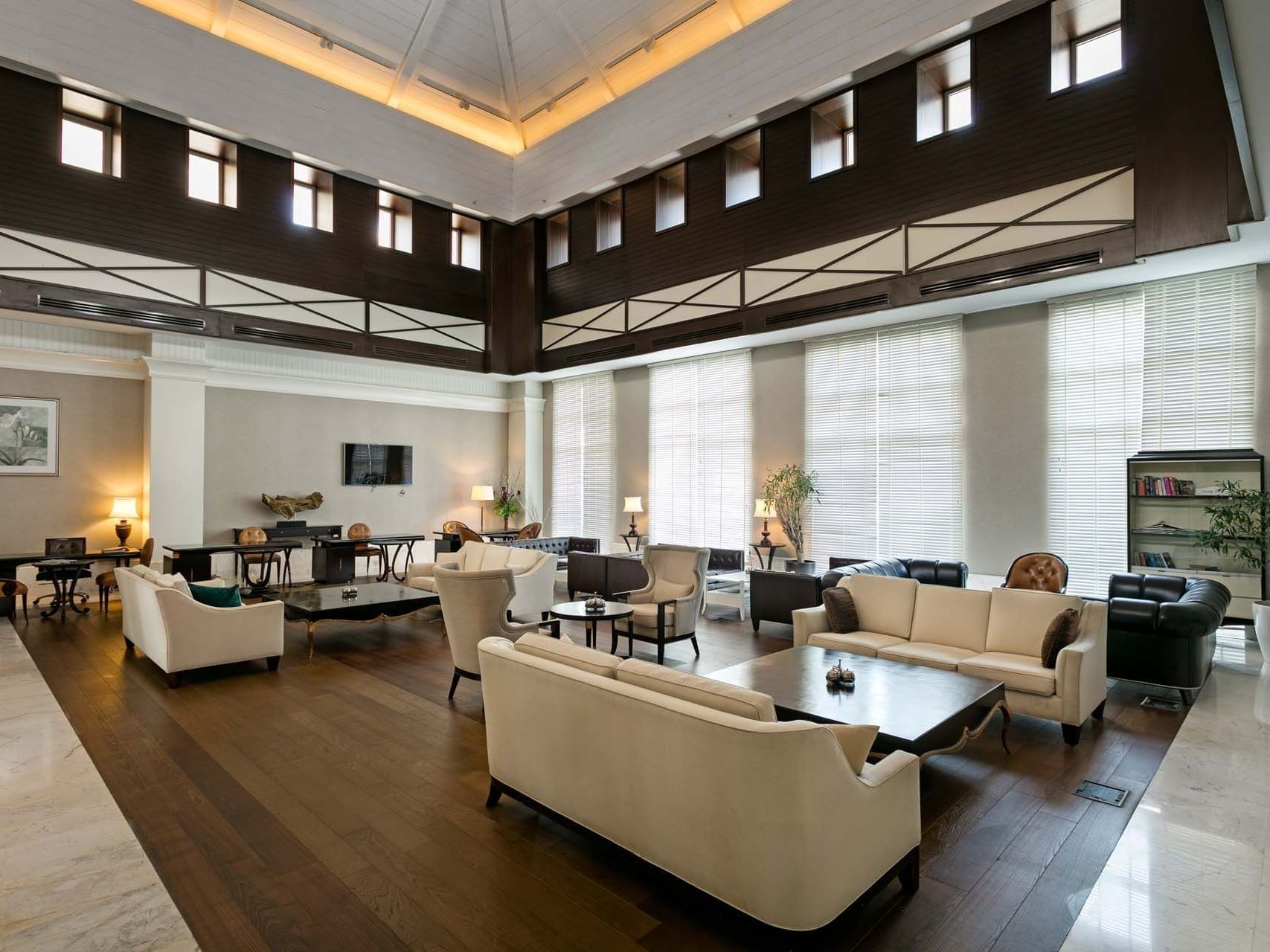 Lobby arranged with cozy sofas and armchairs at Titanic Deluxe Golf Belek