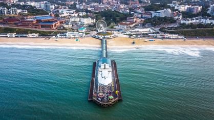 An aerial view of a jetty & city near Village Hotels