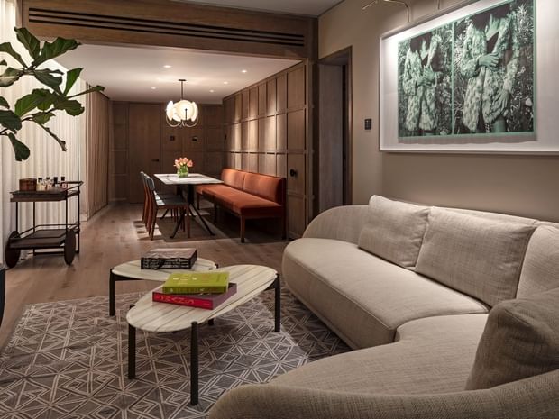 Capital Suite living area with dining table and contemporary decor at The Londoner Hotel
