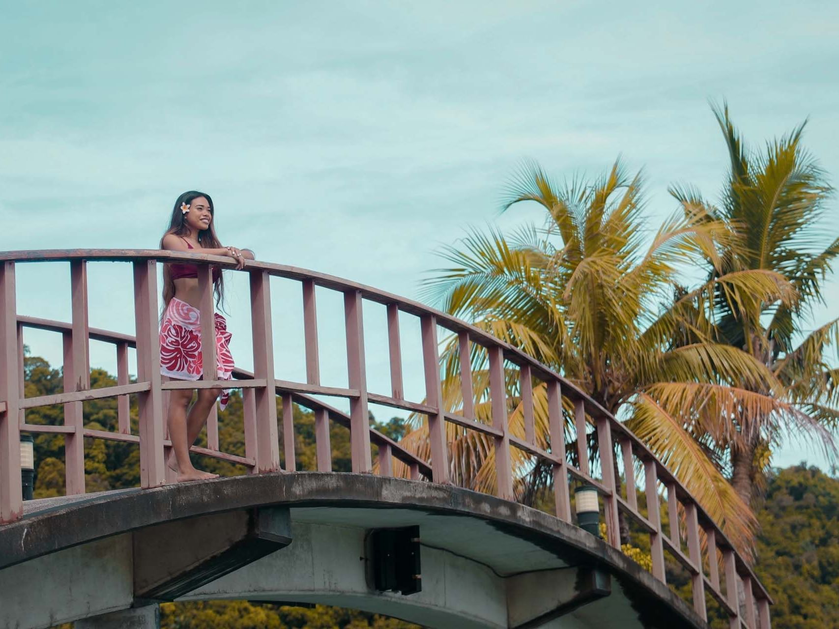 A girl standing on a bridge at Palau Royal Resort