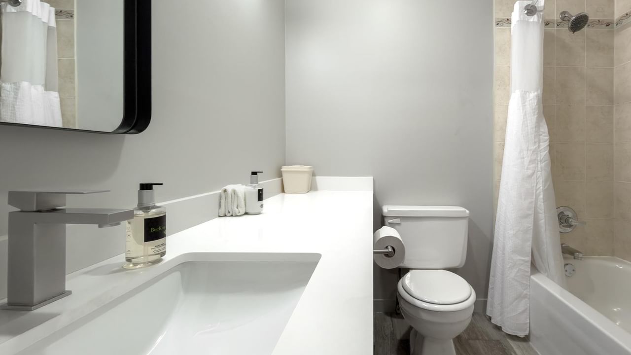 Clean bathroom with sink, toilet, and bathtub at Coast Dawson Creek Hotel.