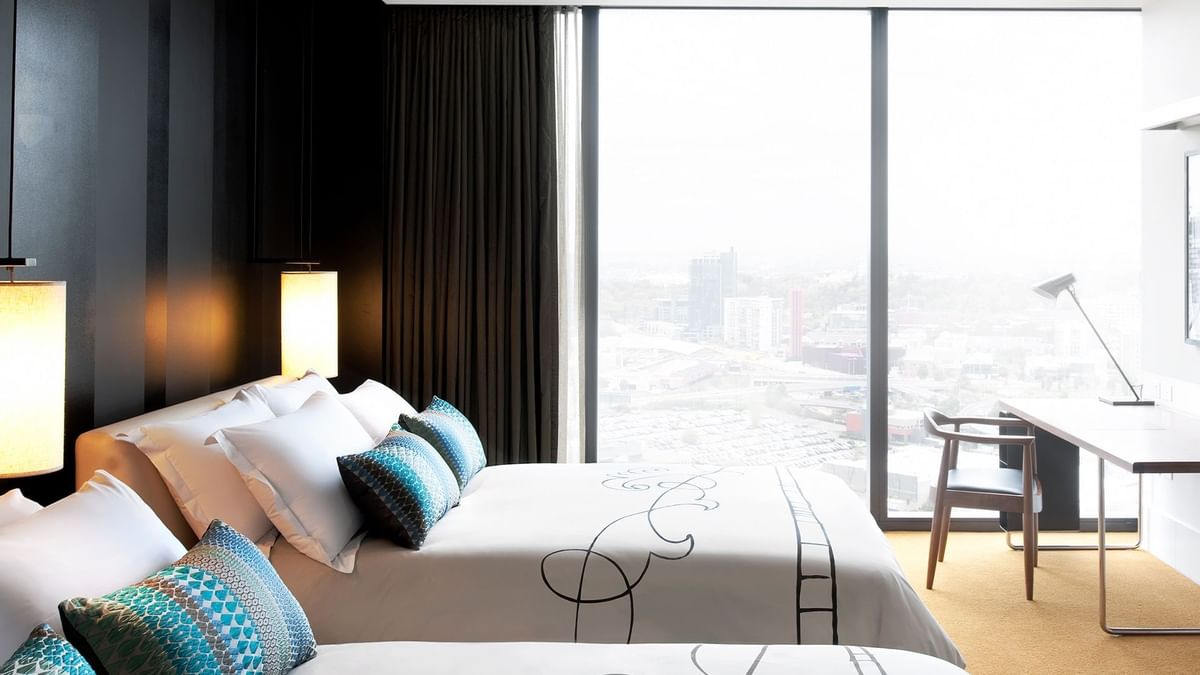 Work desk facing the beds in High Floor Luxe Twin with a city view at Crown Hotels