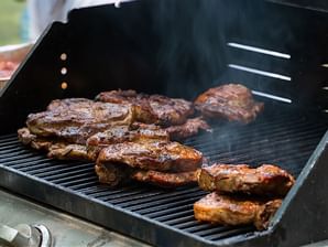 Close-up of pork chop on BBQ grill at Legacy Vacation Resorts