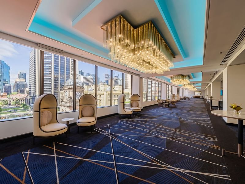 Ann St Lobby with modern pod seating, crystal chandeliers, and city views at Sofitel Brisbane Central