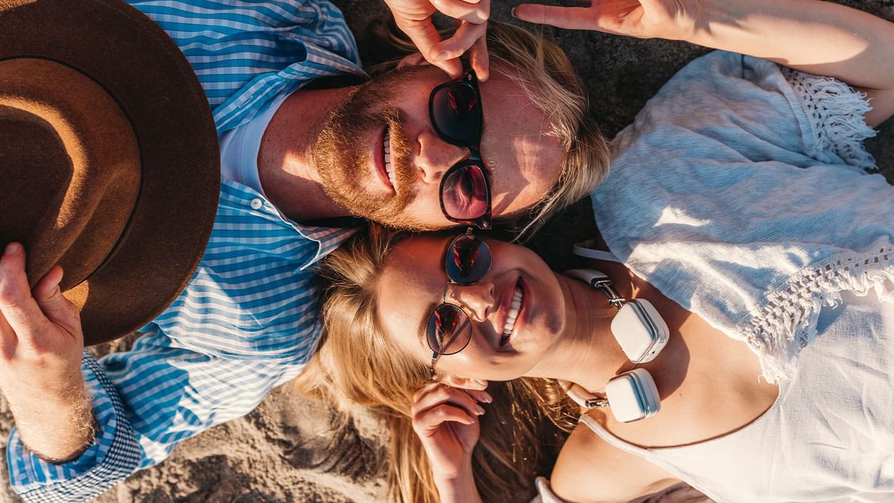 couple lying head-to-head in the sand