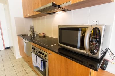 The kitchen with appliances, Studio, Nesuto Canberra Apartment