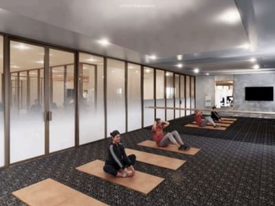 People practicing yoga in a modern gym at UniLodge Brisbane City.