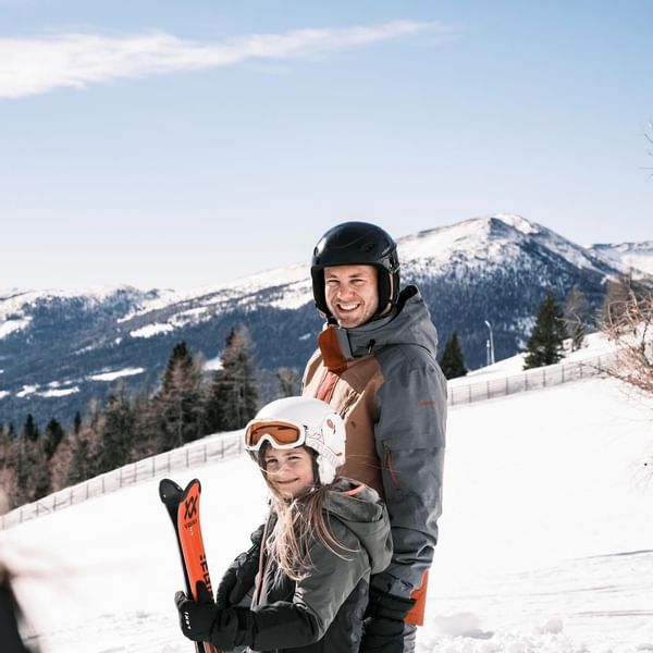 Dad and kid on skiing activities near Falkensteiner Hotels