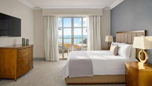 TV & side cupboard facing the bed in The Saasil Suite at Kempinski Hotel Cancún