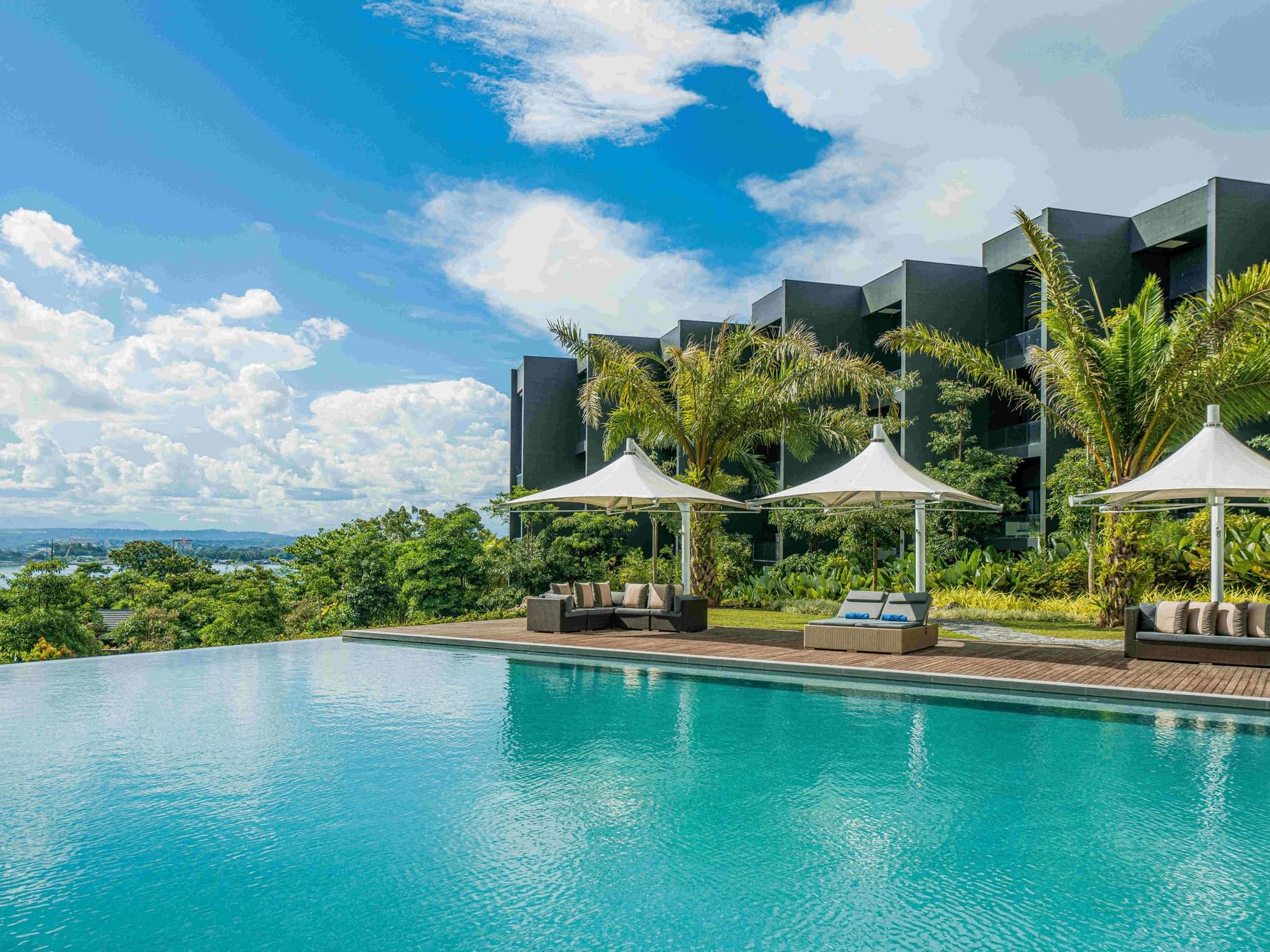 Lounges by the Infinity pool with a city view, Discovery Samal