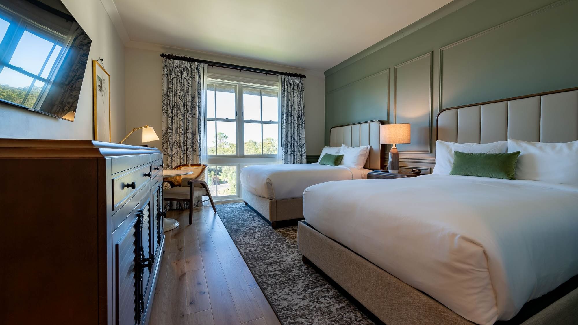 Drawers & TV facing the twin beds in Golf View Queen Room at Camp Creek Inn