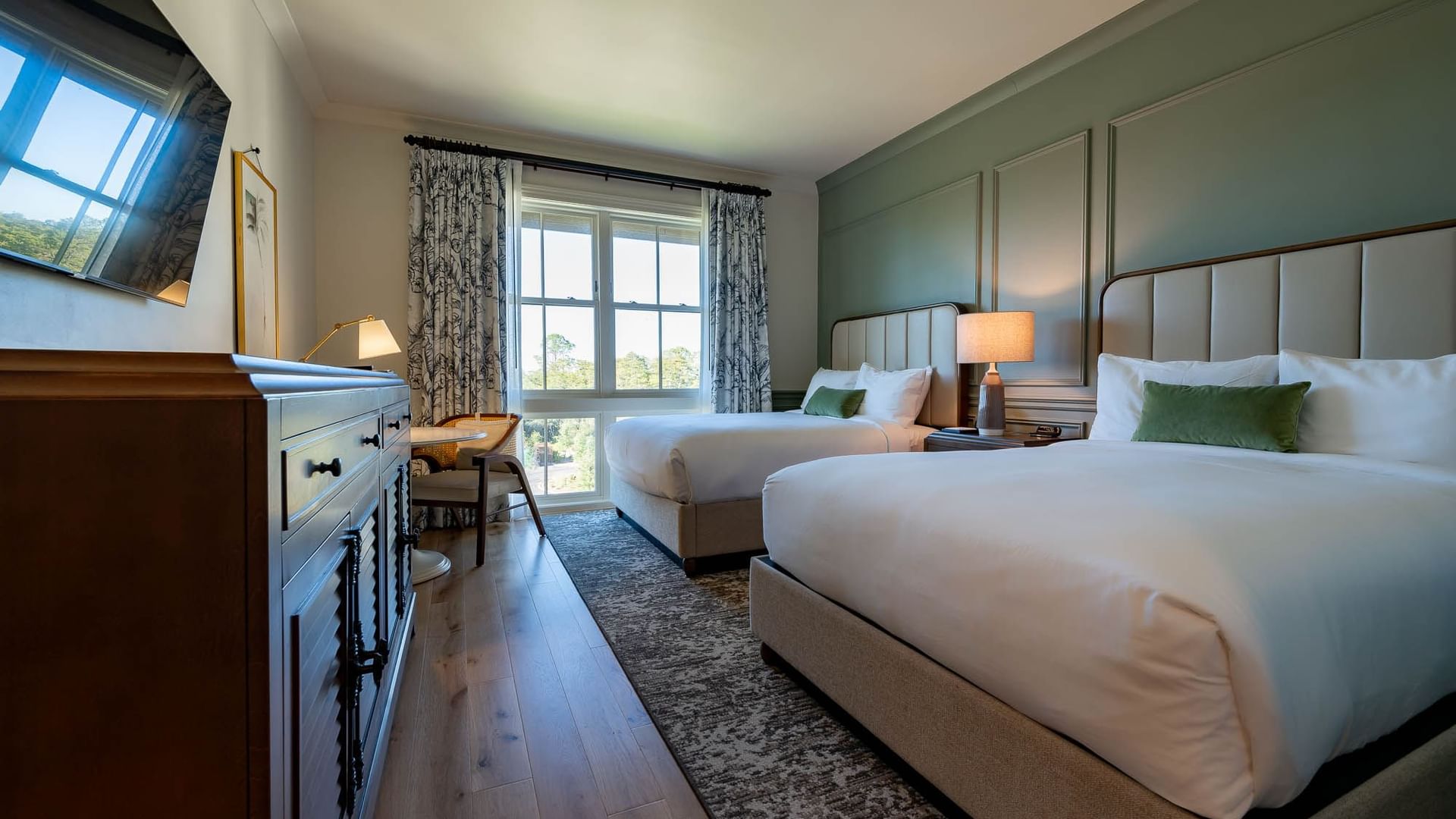 Drawers & TV facing the twin beds in Golf View Queen Room at Camp Creek Inn