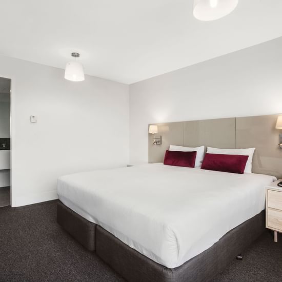 King bed and side desk in Mercure Superior One-Bedroom Lakeview Suite at Pullman Albert Park