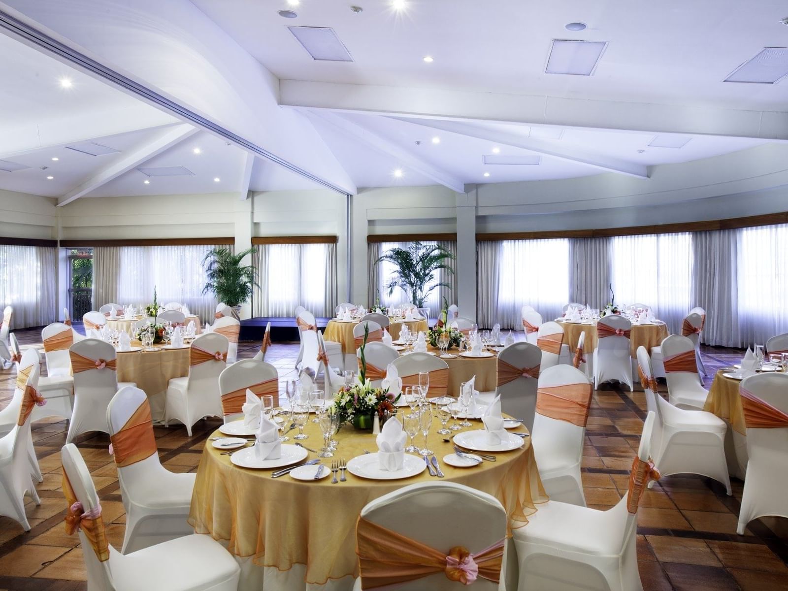 Banquet tables arranged with decors in EI Roble Hall at Fiesta Resort