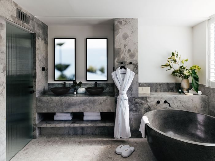 Elysium Two Bedroom Suite at Elysium Manly with a black tub by twin sinks under mirrors, offering cozy Manly accommodation