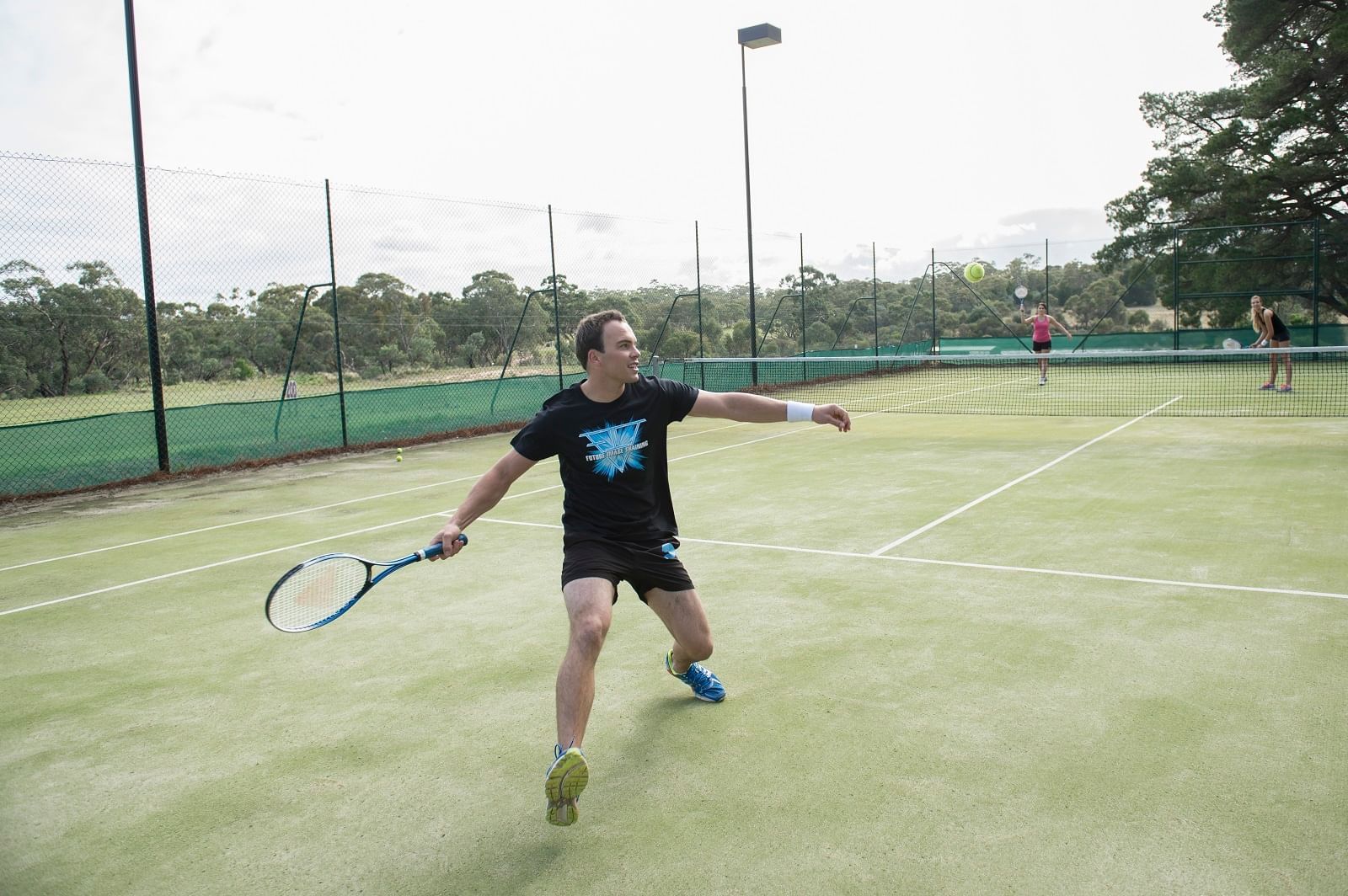 A man playing tennis at Novotel Barossa Valley