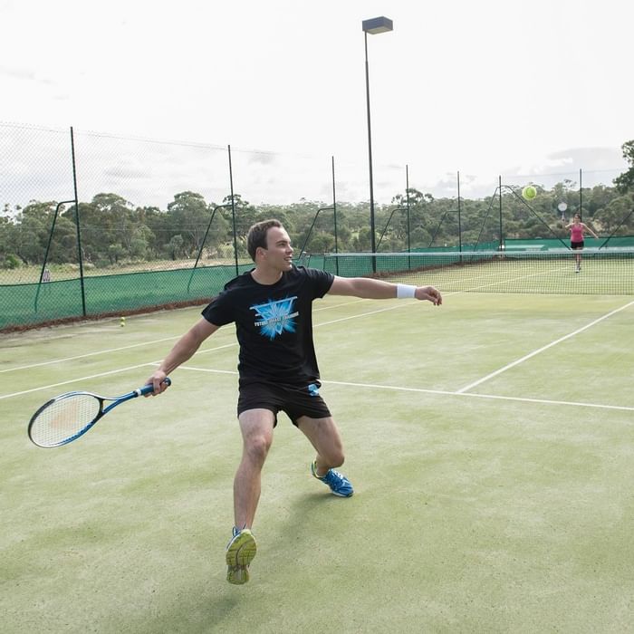 A man playing tennis at Novotel Barossa Valley