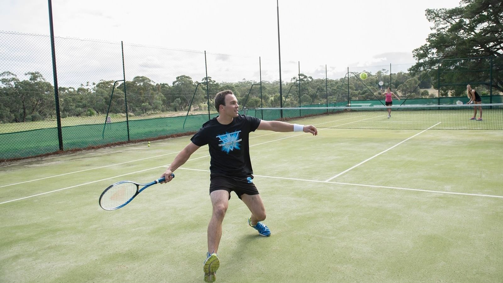 A man playing tennis at Novotel Barossa Valley